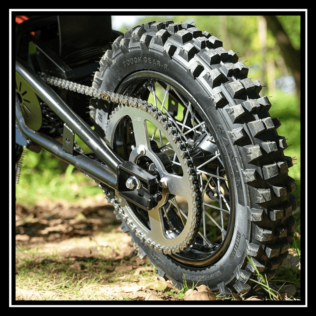 Close-up of the rear wheel of the 🇮🇪🇪🇺🇬🇧🇺🇸 VIPCOO H3 3500W E-DIRT BIKE on rough terrain, showcasing its rugged tire design.