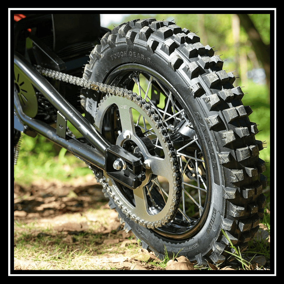 Close-up of the rear wheel of the 🇮🇪🇪🇺🇬🇧🇺🇸 VIPCOO H3 3500W E-DIRT BIKE on rough terrain, showcasing its rugged tire design.