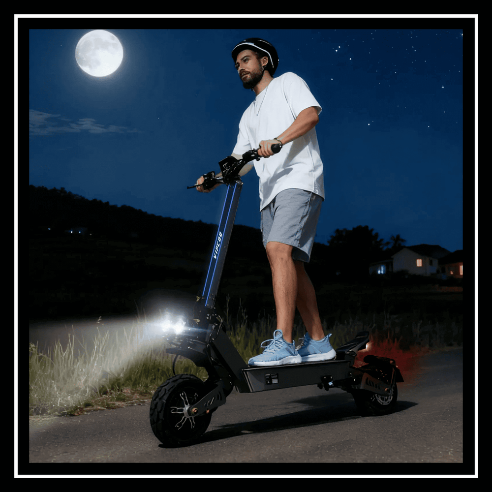 A man rides the ELECTRIC SCOOTER VIPCOO VS9 at night with bright lights under the moon.