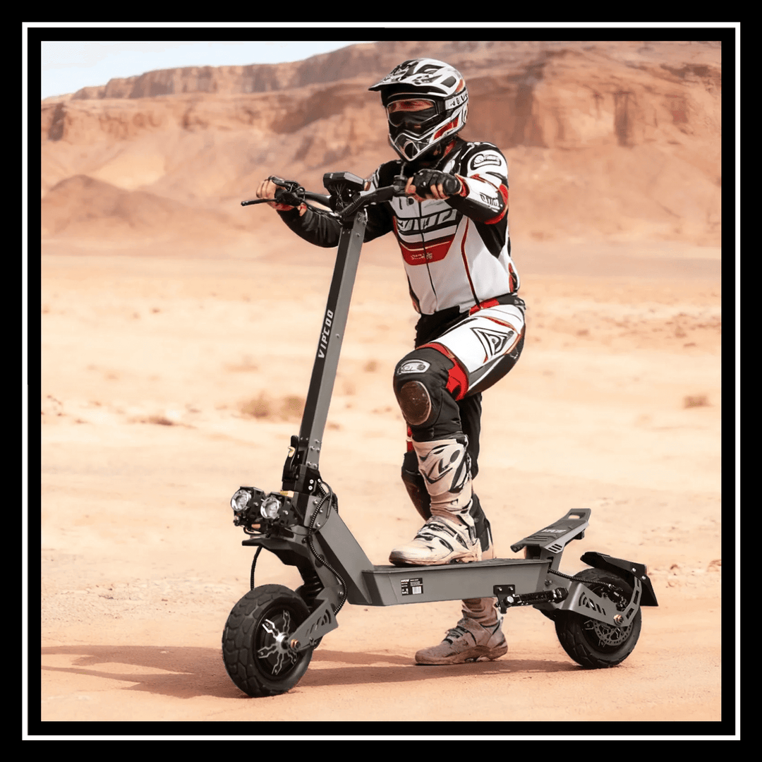 Rider on a VIPCOO VS9 ELECTRIC SCOOTER in a desert landscape, showcasing its rugged design and off-road capability.
