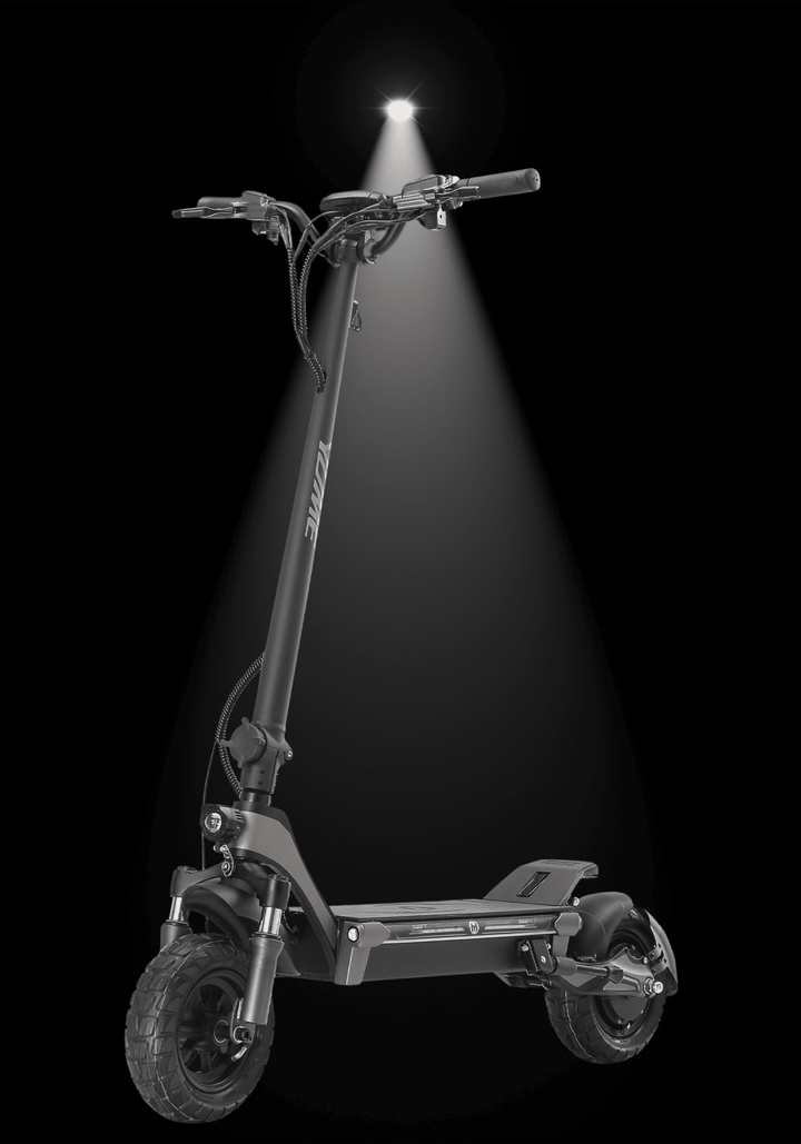 Yume Swift electric scooter illuminated against a black background highlighting its sleek design and features.