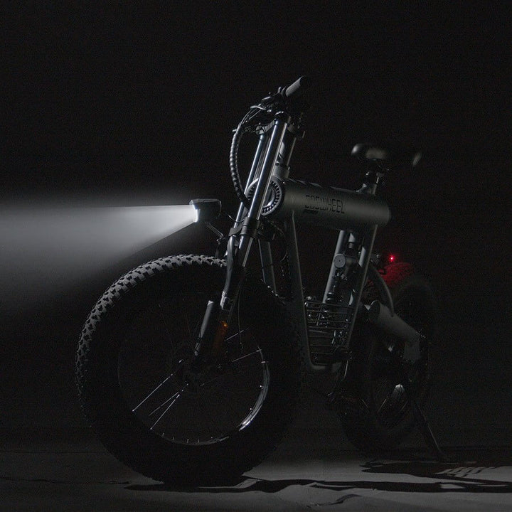 COSWHEEL T20 electric bike illuminated in dark setting, showcasing its design and strong performance features.