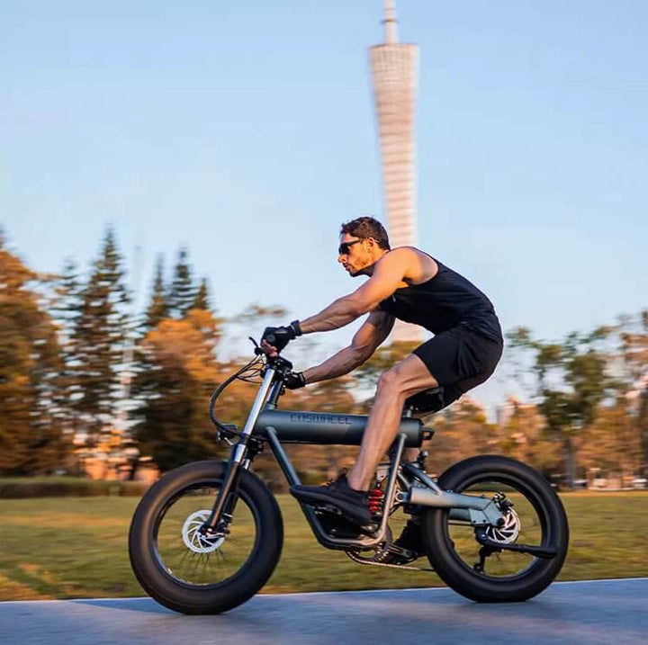 Rider enjoying the COSWHEEL T20 electric bike in an urban park setting, showcasing its sleek design and performance.