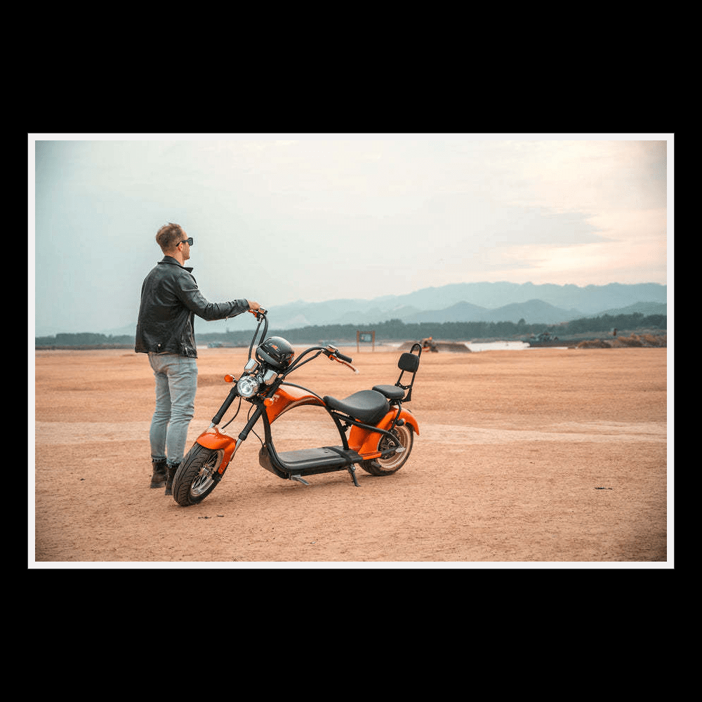 EAHORA MP1 two-seat electric motorcycle parked on a sandy landscape with a rider in sunglasses.