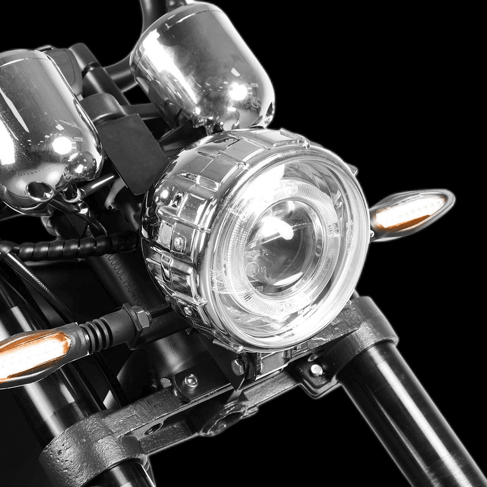Close-up of the EAHORA M1P PLUS electric motorcycle headlight and chrome accents.