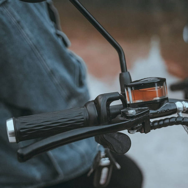 Close-up of EAHORA M1P PLUS electric motorcycle handlebars with brake and throttle controls.