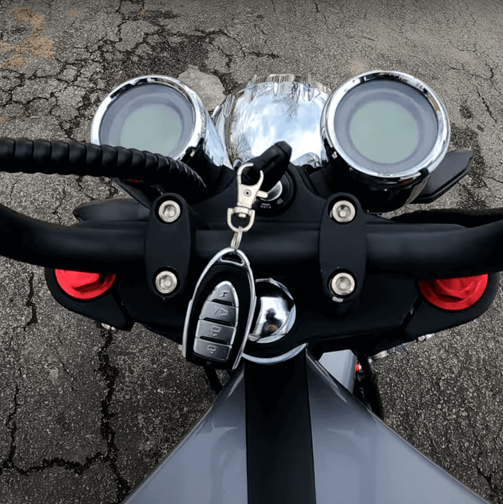 Overhead view of the handlebars of the EAHORA M1P PLUS electric motorcycle, showcasing the control panel and key.