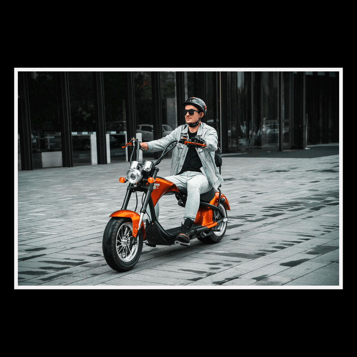 EAHORA MP1 two-seat electric motorcycle in an urban setting with a rider wearing sunglasses and a helmet.