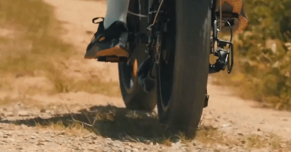 ENGWE Engine X Electric Bike riding on gravel path showcasing sturdy fat tires and reliable performance.