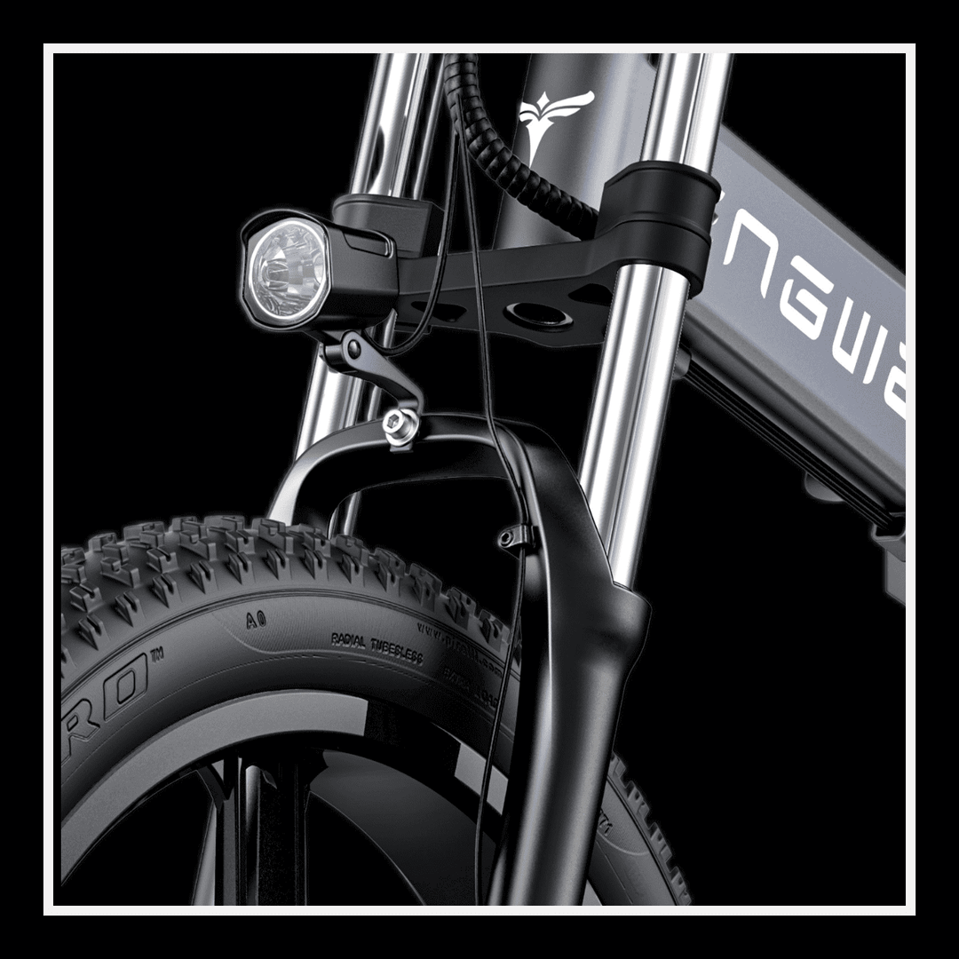 Close-up of the front suspension and light of the Engwe X26 electric bike with strong fat tires.