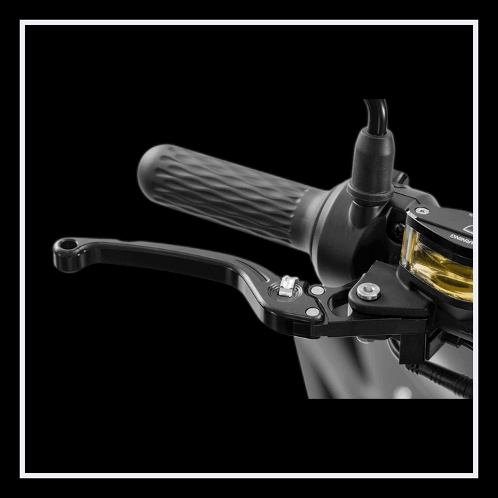 Close-up of the INTHEZONE M1PS electric motorcycle throttle and brake lever with textured grip.