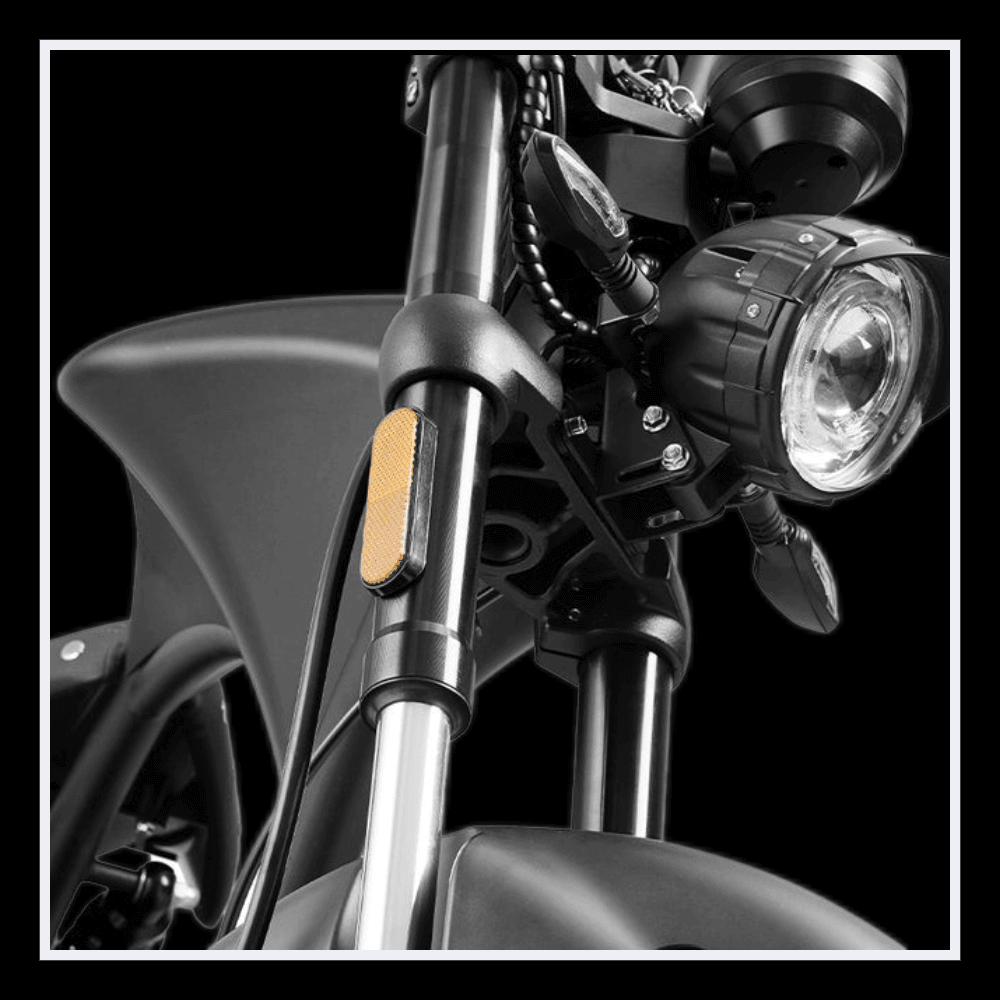 Close-up of INTHEZONE M1PS electric motorcycle front fork and headlight features.