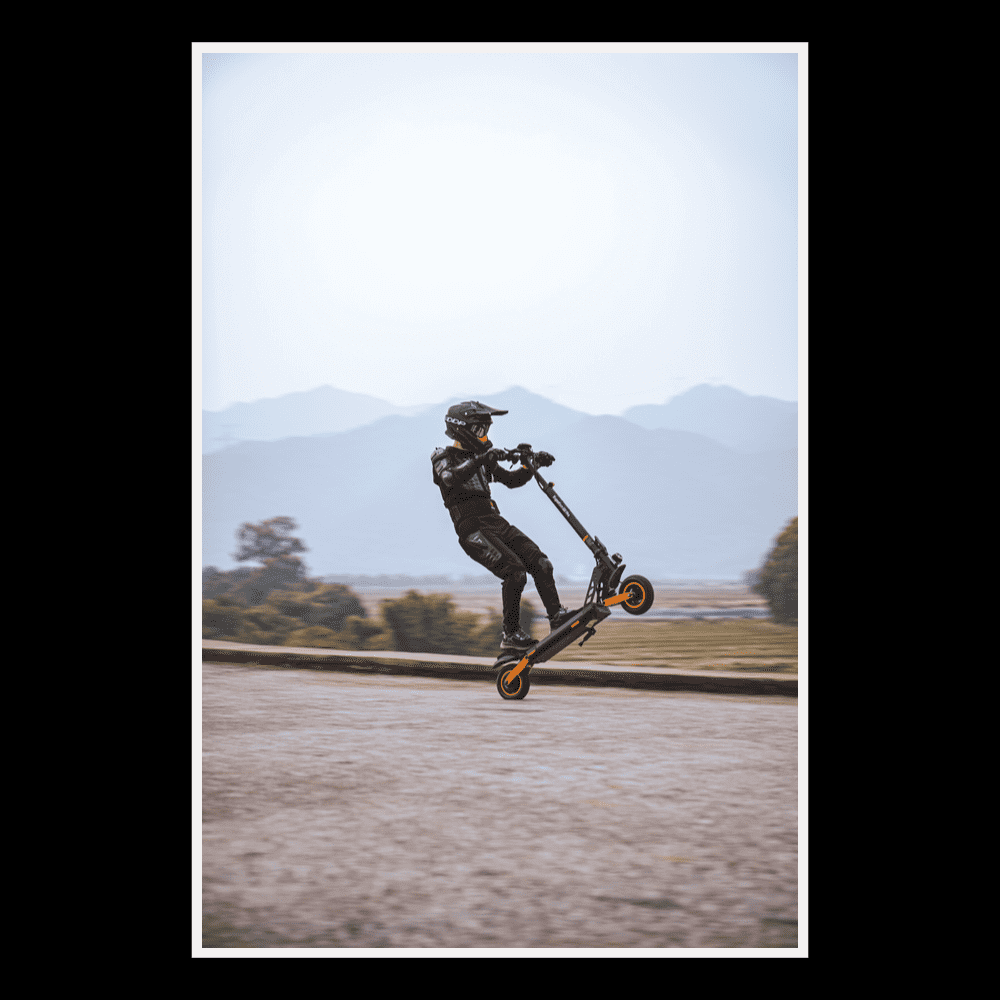 Person riding KUKIRIN G2 Pro electric scooter in urban environment performing a stunt.