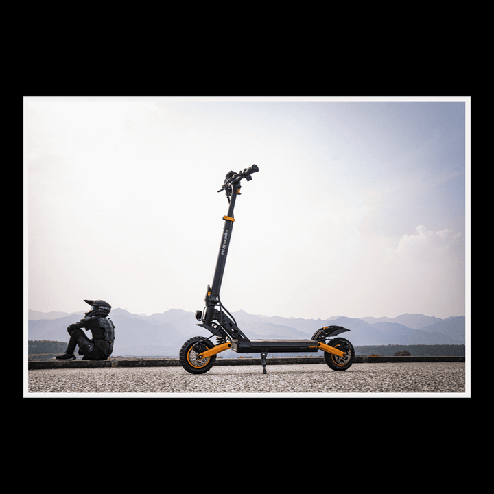 KUKIRIN G2 Pro electric scooter parked on a road with a rider resting nearby, showcasing its urban design.