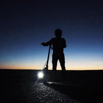 Person riding a KUKIRIN G3 electric scooter at sunset, highlighting its performance and design features.