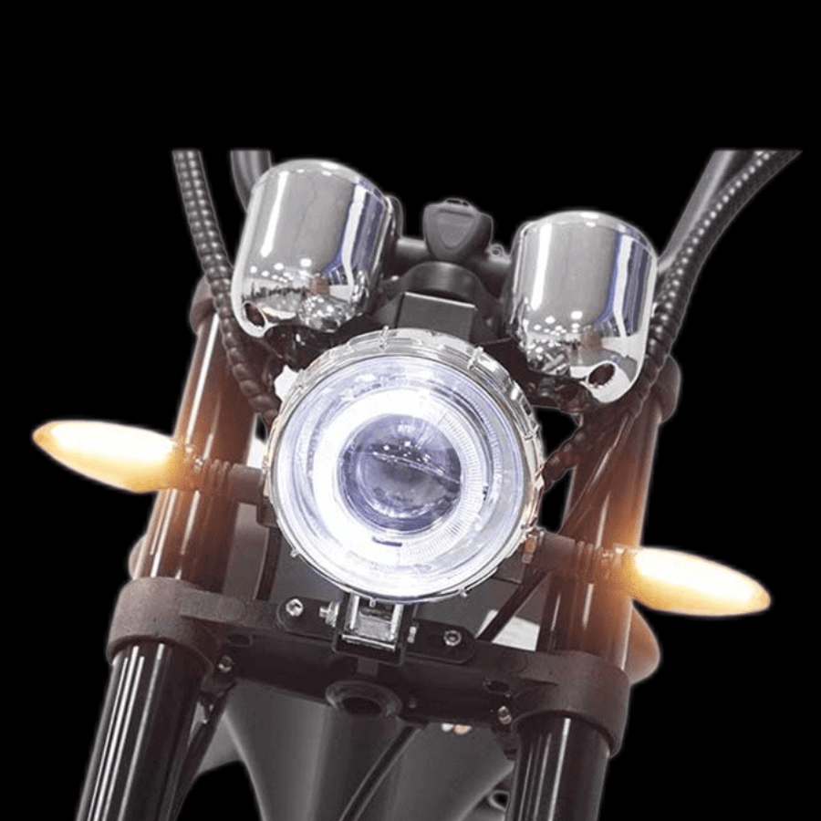 Front view of M1P electric chopper motorcycle showcasing headlight and indicators.