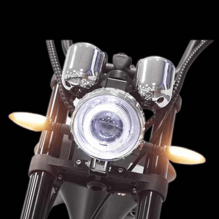 Front view of M1P electric chopper motorcycle showcasing headlight and indicators.