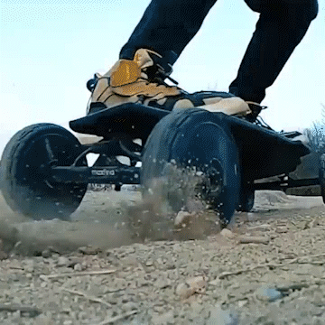 Maxfind FF AT electric skateboard riding on rough terrain, showcasing all-terrain capabilities and powerful performance.