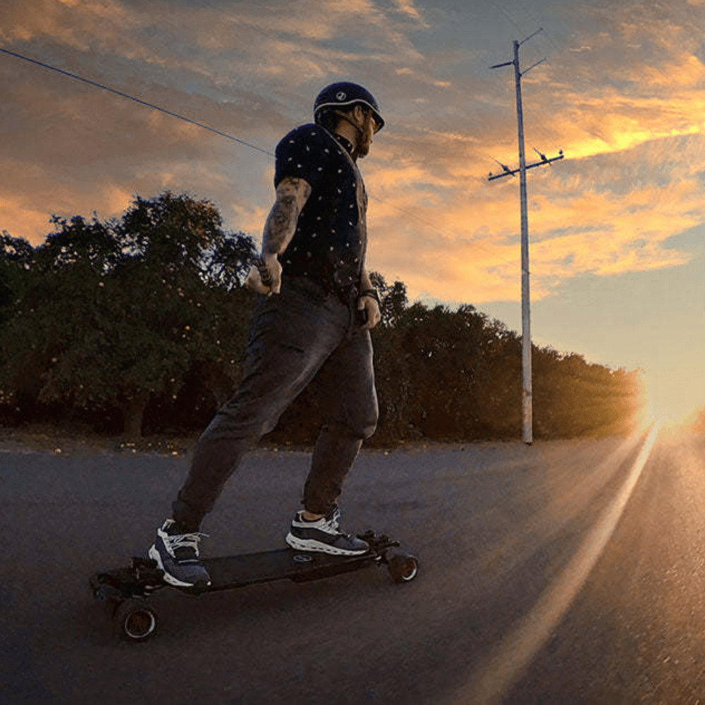 A person skateboarding at sunset on a MAXFIND FF BELT belt-driven electric skateboard.