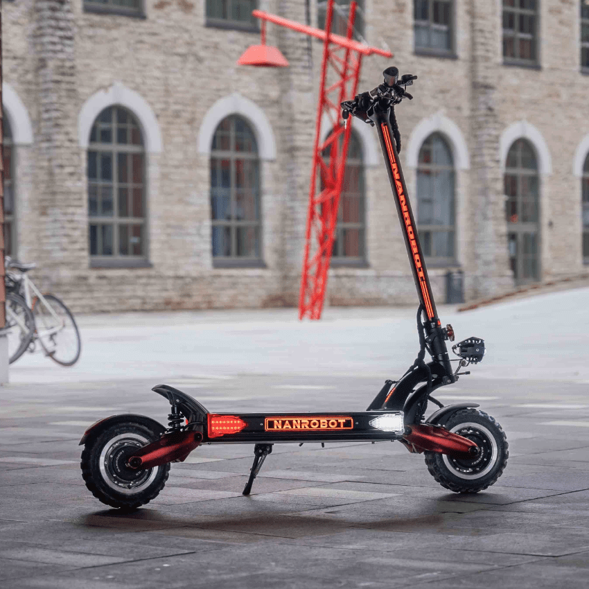 Nanrobot LS7+ electric scooter standing in an urban setting with modern architecture in the background.