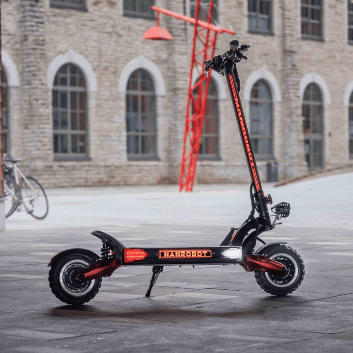 Nanrobot LS7+ electric scooter standing in an urban setting with modern architecture in the background.