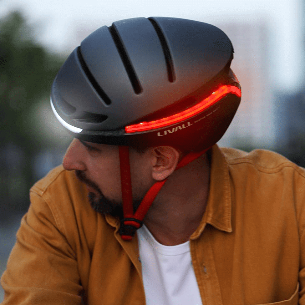 smart bike helmet EVO21 with LED lights, designed for safety during urban commuting, worn by a rider.